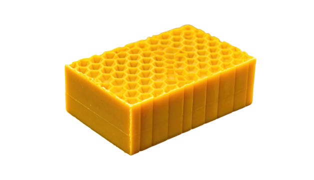 A bright, rectangular beeswax block with repeating hexagonal patterns and smooth sides, on a black background