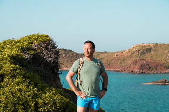 Confident hiker enjoying scenic coastal landscape