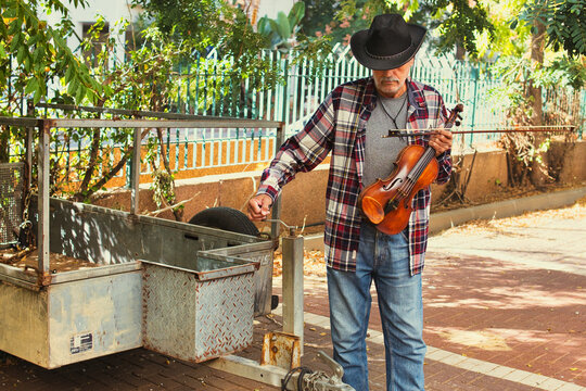 Cowboy Musician Adjusting Trailer Hitch Outdoors