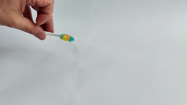 Used toothbrush with frayed bristles on a white background. Aged hygiene tool showing wear, discoloration, and the need for regular replacement in dental care routines