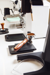 Barista Workspace Setup With Portafilter and Freshly Ground Coffee on Scale for Precise Espresso Preparation