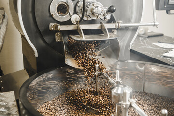 Freshly Roasted Coffee Beans Pouring From the Roaster Into the Cooling Tray in Roasting Facility