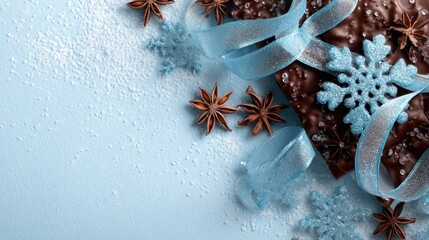 Festive chocolate bark with snowflakes and ribbons on a light blue background