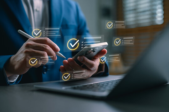 Businessman using smartphone with digital checklist and task management interface. Concept of productivity, workflow optimization, mobile planning, and business organization with digital tools.