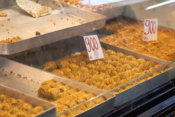 Trays of fresh Turkish baklava with price tags in a shop display