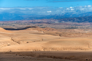 Vast landscape of Agafay in the Moroccan desert showing arid terrain and distant mountains