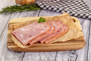 Sliced porjk ham over boatd