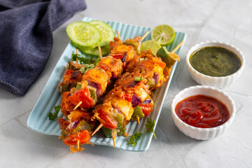 Paneer satay is a grilled Indian appetizer made with marinated paneer cubes, skewered, and served with spicy peanut or yogurt dip.
