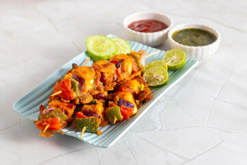 Paneer satay is a grilled Indian appetizer made with marinated paneer cubes, skewered, and served with spicy peanut or yogurt dip.
