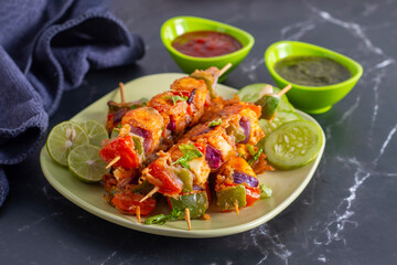 Paneer satay is a grilled Indian appetizer made with marinated paneer cubes, skewered, and served with spicy peanut or yogurt dip.
