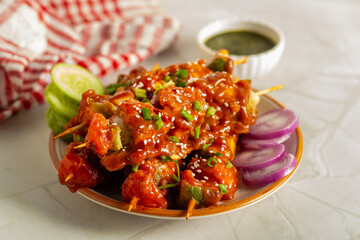 Paneer satay is a grilled Indian appetizer made with marinated paneer cubes, skewered, and served with spicy peanut or yogurt dip.
