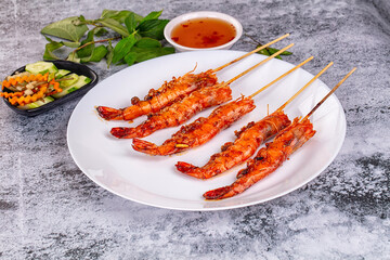 Grilled prawn skewer served sauce