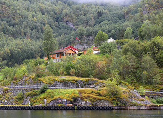 Colorful Homes with flying Norwegian Flag by The Pier in Flam, Norway