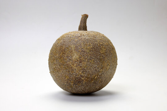 Hard shelled rare exotic fruit sour tangi wood apple kod bel on white background