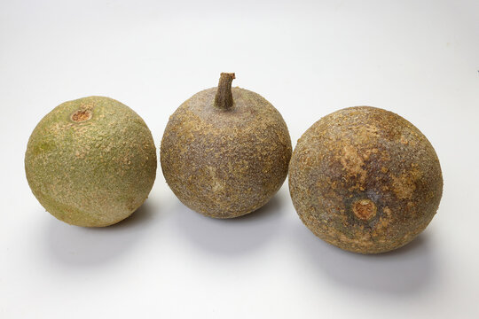 Hard shelled rare exotic fruit sour tangi wood apple kod bel on white background