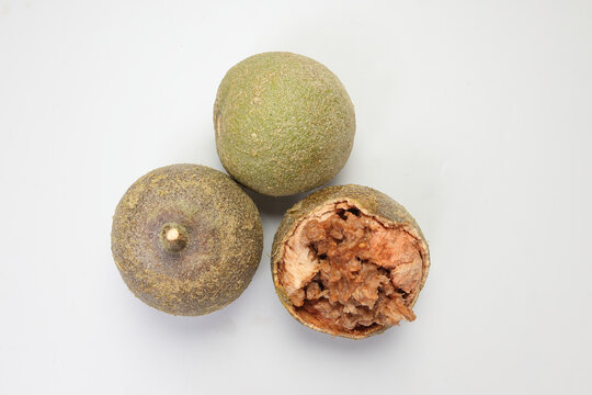 Hard shelled rare exotic fruit sour tangi wood apple kod bel on white background
