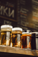 Four Distinct Beers Showcased in Glasses on Bar Counter
