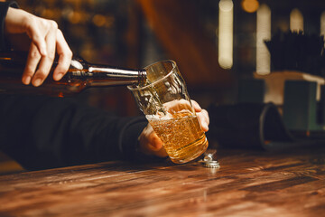 Unrecognizable Bartender Pours Beer Into Clean Glass at Bar Close up
