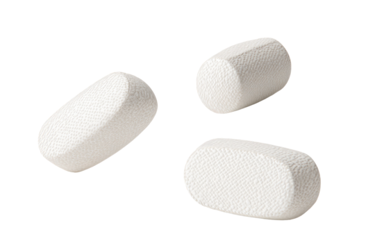 Three white, textured oval tablets, isolated