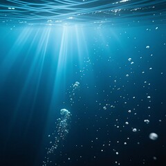 Radiant sunlight beams pierce the clear deep blue ocean surface Numerous air bubbles ascend through the water column