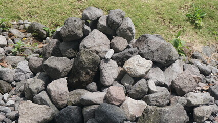 A pile of neatly arranged gray stones, outdoors, taken in closeup
