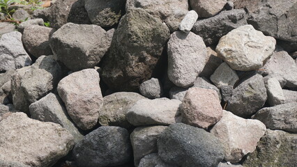 A pile of neatly arranged gray stones, outdoors, taken in closeup