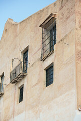 Pastel Stucco Facade with Wrought-Iron Balconies and Barred Windows, Mediterranean Architecture