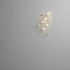 Elegant background featuring luminous pearl spheres and golden beads against a soft gray backdrop