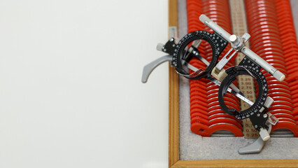 Close-up of a trial lens set with trial frame used for eye exams in optometry, showing various...