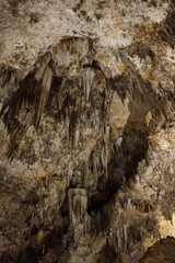 Vertical Cave Ceiling with Hanging Stalactites and Rich Limestone Texture, Dramatic Shadows