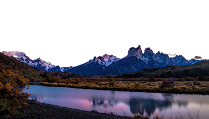 Snowy peaks loom over river, landscape glows with soft light