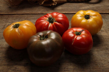 variety assortment of tomato red yellow maroon beef breakfast on rustic wood jute rope table background