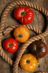 variety assortment of tomato red yellow maroon beef breakfast on rustic wood jute rope table background