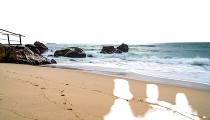 Sandy beach meets the foamy sea, rocks stand guard