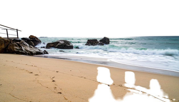 Sandy beach meets the foamy sea, rocks stand guard