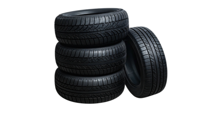 Stack of four black tires. One tire stands angled