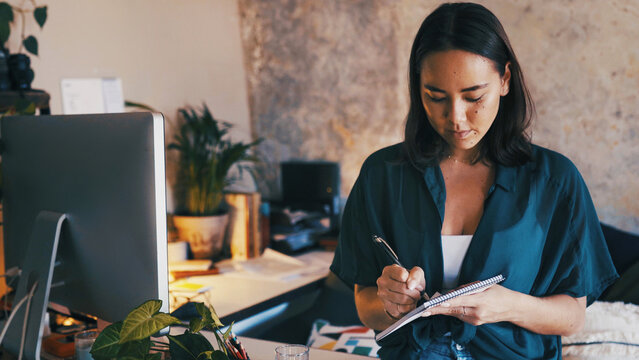 Remote work, woman and writing in notebook in home office for appointment, schedule or reminder. Freelancer, personal assistant and planning with notepad in apartment for admin tasks and to do list