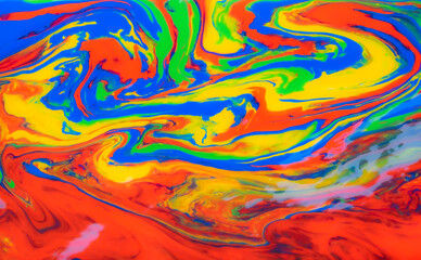 vibrant abstract painting features swirling, fluid patterns in rich colors. The bold, dynamic strokes create a sense of movement. The artwork, evokes a sense of energy and fluidity.
