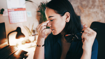 Business, night and woman with headache, eye strain and tired with fatigue, burnout and pain. Late, person and employee in office, blue light exposure and exhausted with tension, glasses and ache