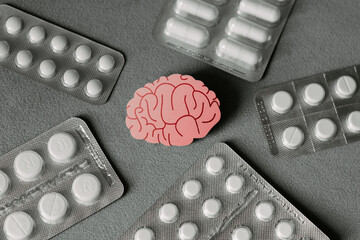 Pink brain with pills top view. Awareness of brain diseases. Prevention od dementia