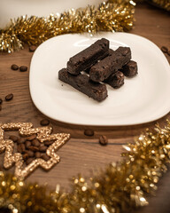 Chocolate brownies with gold decorations.