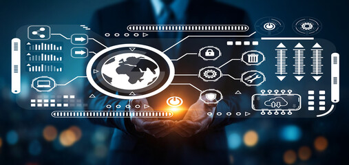 Businessman holding digital world globe with technology icons and data streams in urban night setting, illustrating global connectivity and innovation themes
