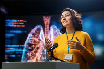 woman is giving a presentation at conference