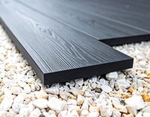Dark gray composite decking planks on gravel base