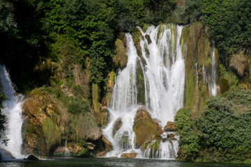 Fototapeta premium Cascading waterfall whispers secrets of ancient earth, celebrating World Water Day, evoking zen contemplation and nature's symphony