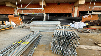 Industrial ballet of scaffolding pipes, urban metamorphosis, echoes of Labor Day construction, building dreams upon skeletal steel