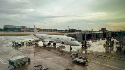 Glistening aircraft basks in post-rain stillness, echoing wanderlust dreams, jet-set equinox journeys, and aviation enthusiasts' gathering