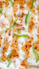 Cheesy prawn pizza with zingy pineapple and fiery chili flakes, ideal for World Pizza Day or quirky beach picnics