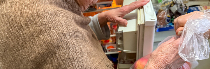 Elderly Caucasian woman's hands weigh apples, evoking harvest nostalgia and Cornucopia...