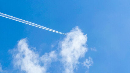 Jet plane etching cotton candy across azure skies, fleeting whispers of wanderlust, International Day of Civil Aviation celebration